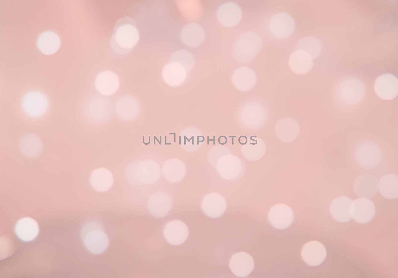 Bokeh lights defocussed festive background texture toned in trend color Living Coral.