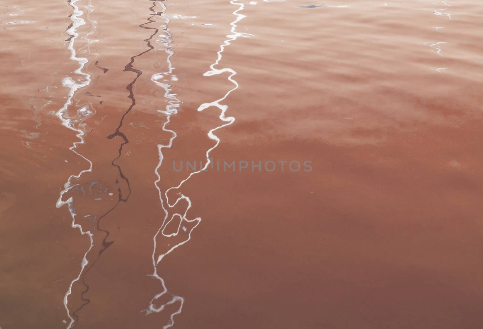 Mast water reflections abstract texture background toned in Living Coral shade