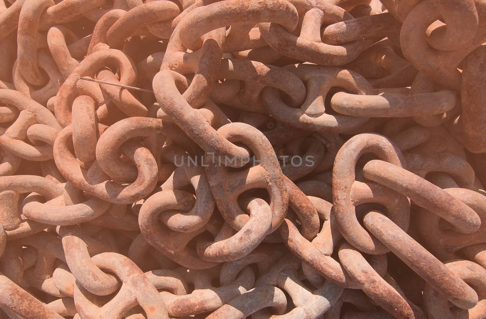 Closeup of rusty boat anchor chains with a tone of Living Coral 