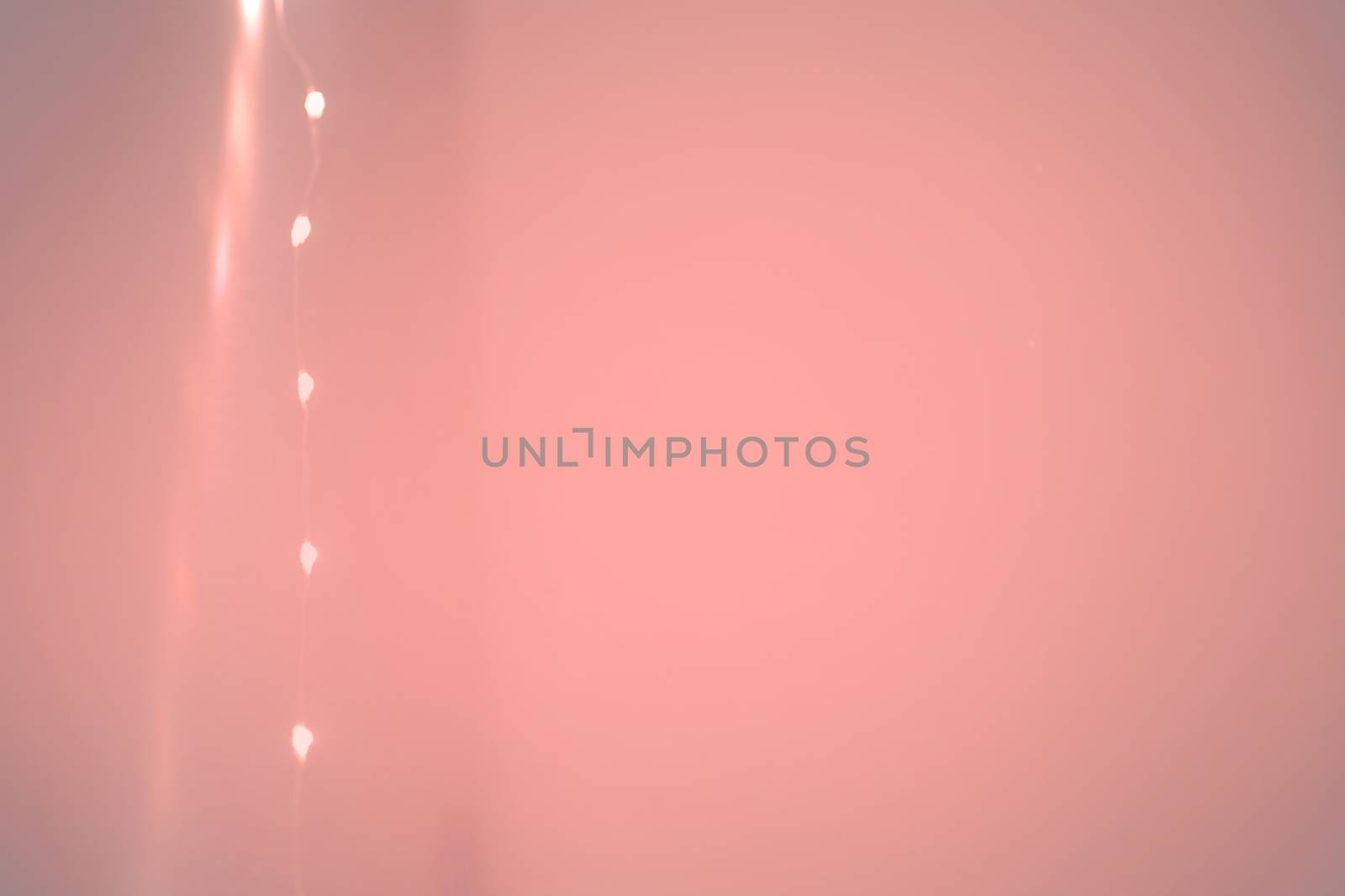 String of lights margin and wall background toned in Living Coral shades