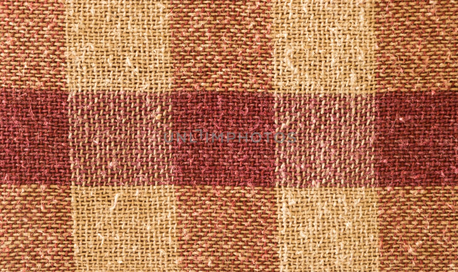 Close up abstract of block checked shape cotton print fabric background. Seamless colorful cloth textile texture of light crisscross pattern. Natural canvas. Studio shot with copy space room for text.