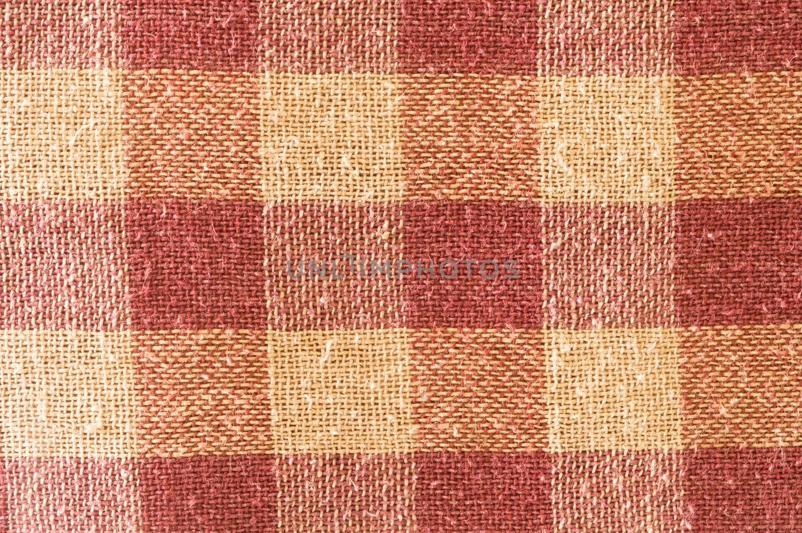 Close up abstract of block checked shape cotton print fabric background. Seamless colorful cloth textile texture of light crisscross pattern. Natural canvas. Studio shot with copy space room for text.