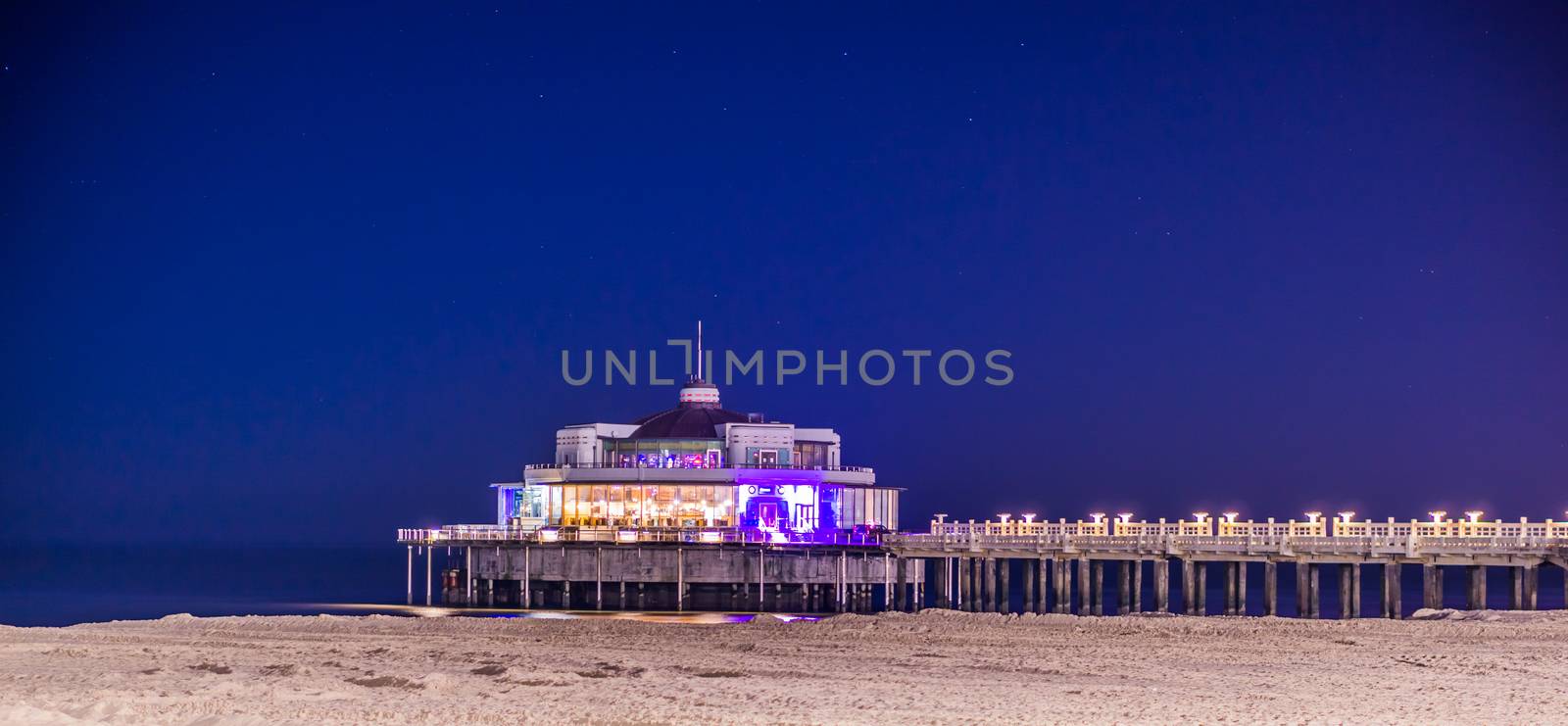 The popular jetty of Blankenberge lighted by night, Architecture of the Belgian coast in Belgium