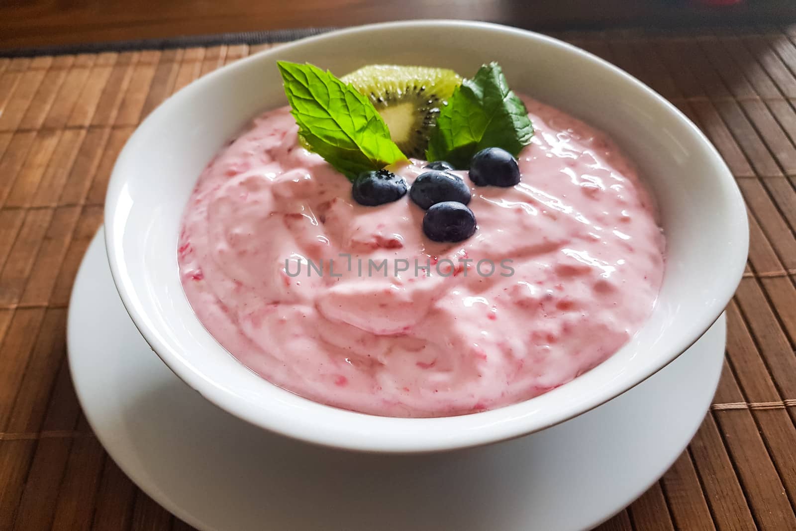Healthy protein breakfast, quark dip, linseed oil with omega 3, fresh fruits and rustic wholemeal bread with tomatoes on a kitchen board, healthy and concentrated meal with natural food