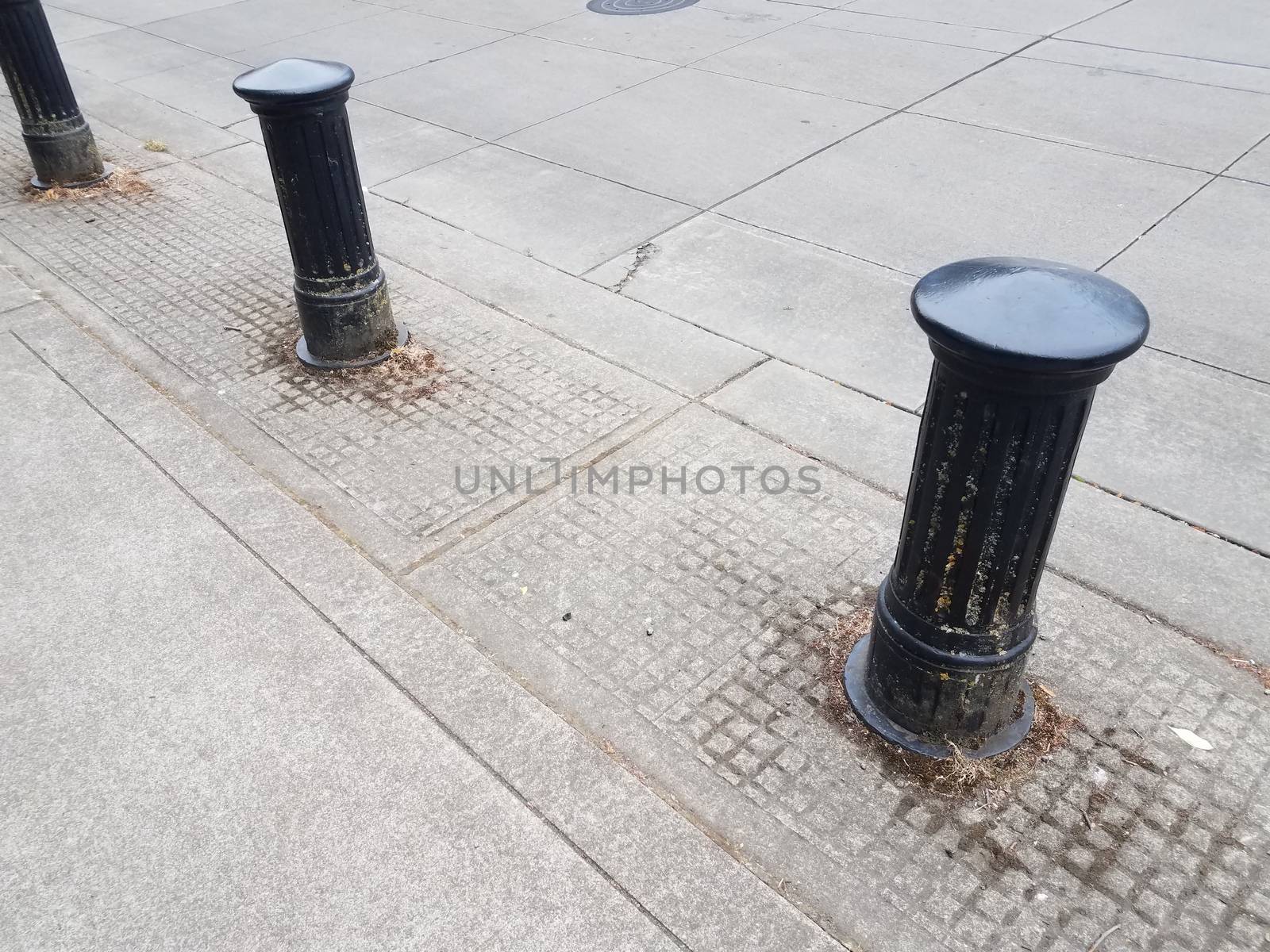 black bollard and street or road with grey cement by stockphotofan1