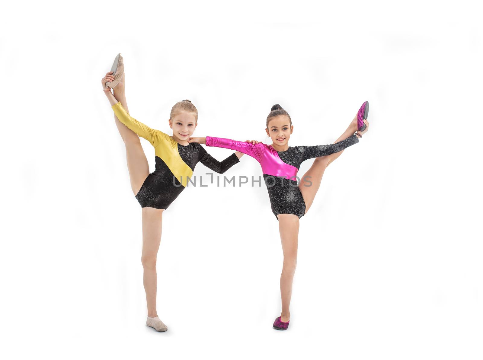 Two gymnastic girls in leotard with leg up isolated on white