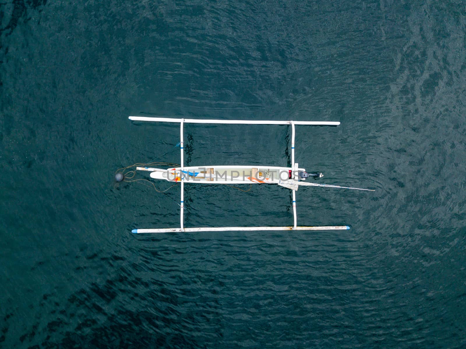 Top down aerial view of traditional Indonesian fishing boat called jukung