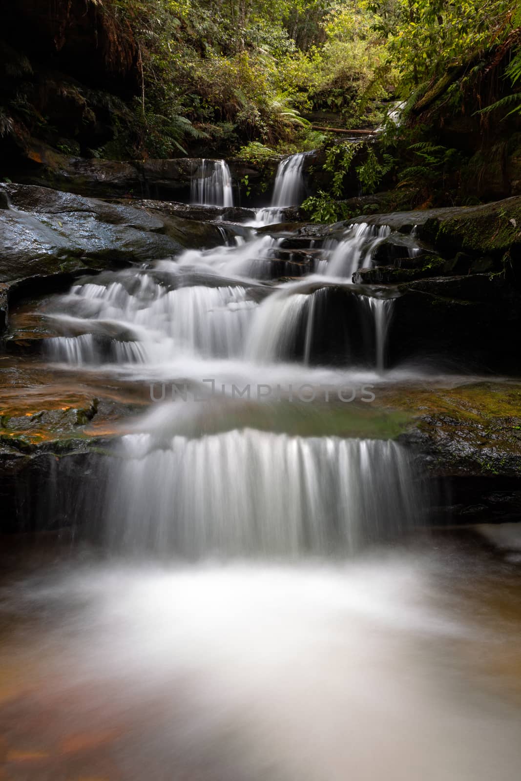 Cascading water through gully into little rock pool by lovleah