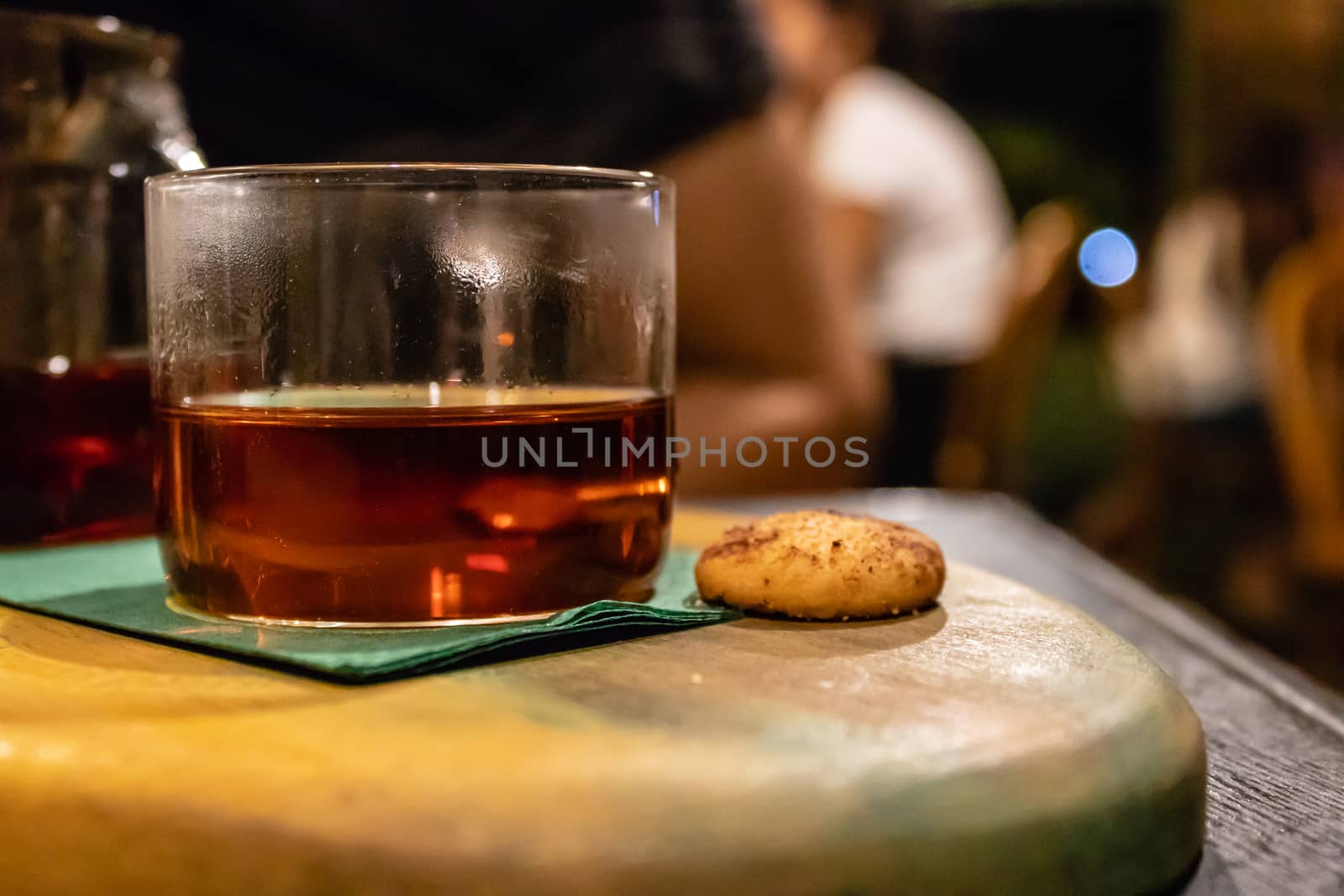 a closeup side view of a glass of tea and cookie. photo has taken from a cafe at izmir/turkey.