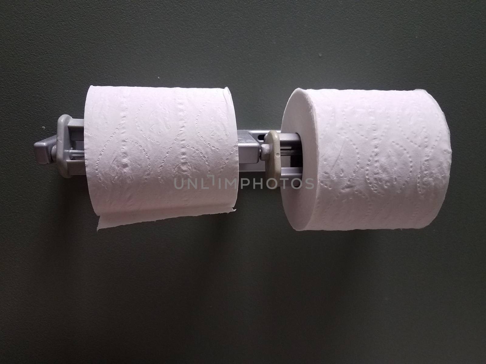 white toilet paper or tissue rolls in bathroom or restroom stall