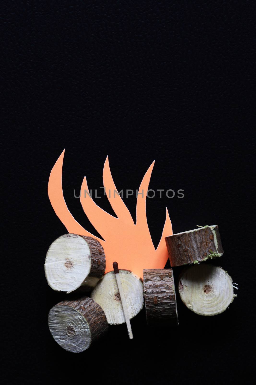 Fire shape cutting from red paper near wood and matchstick