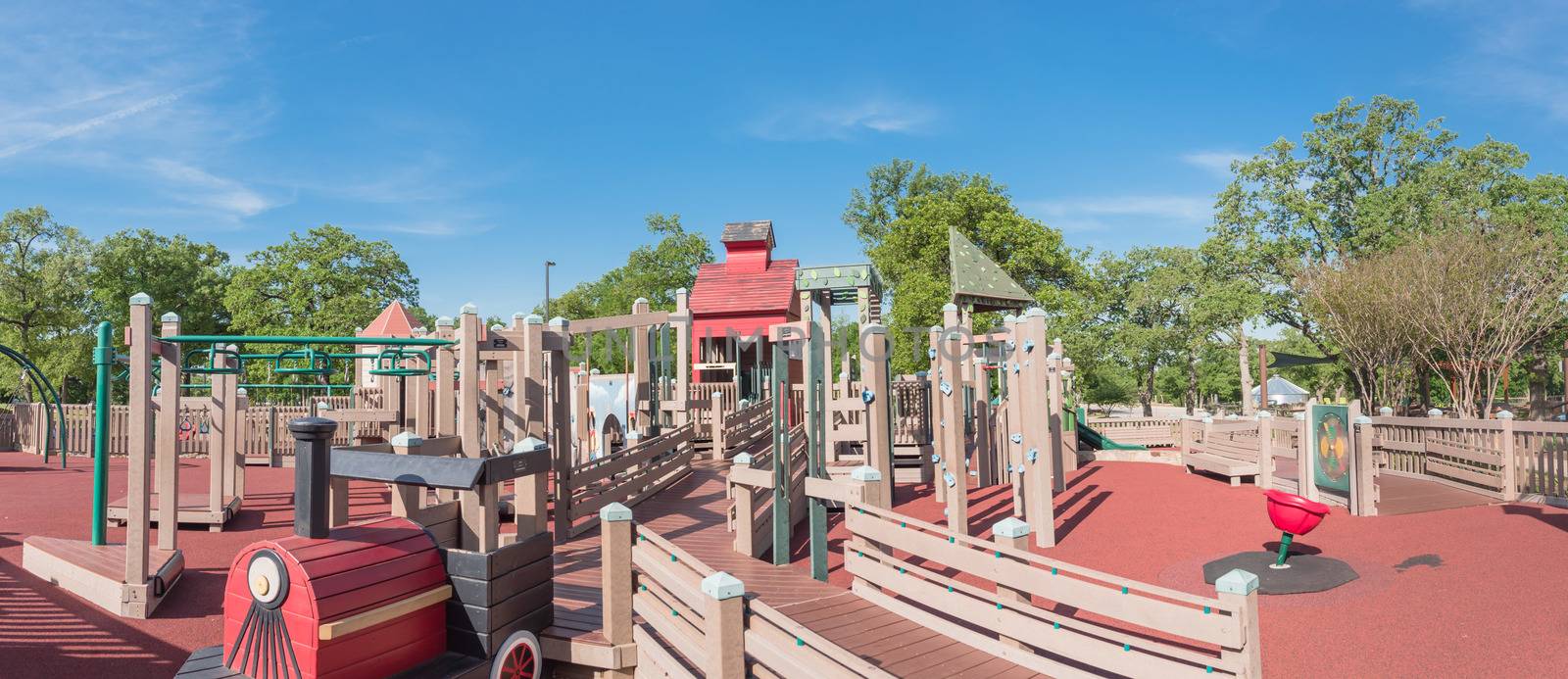 Panoramic kid wooden playground recreation area at American publ by trongnguyen