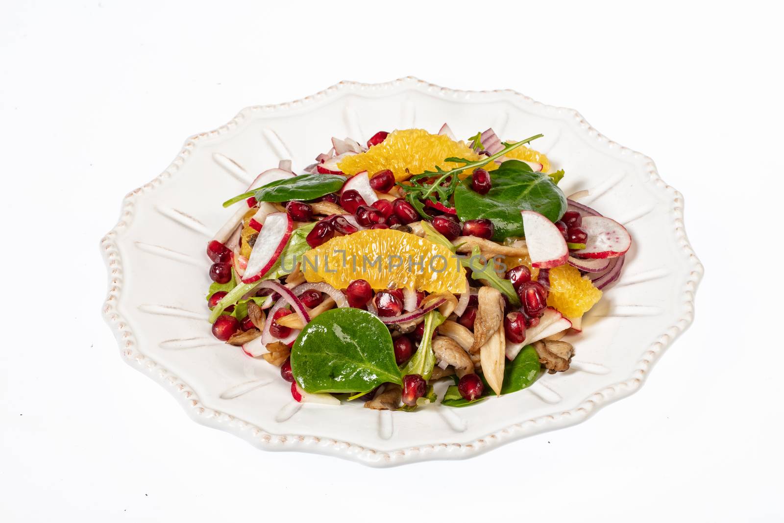 Porcelain plate with salad on an isolated studio background