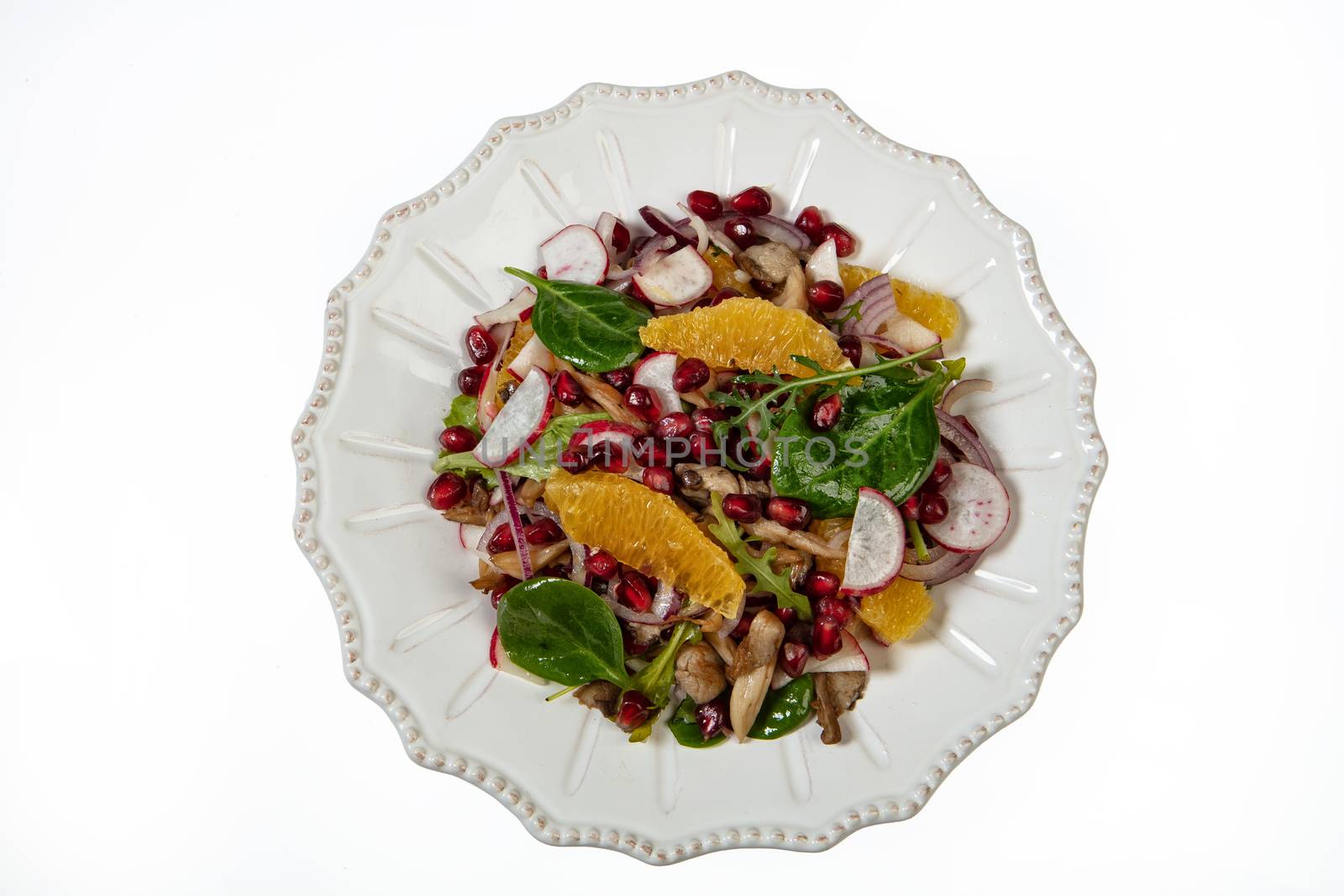 Porcelain plate with salad on an isolated studio background