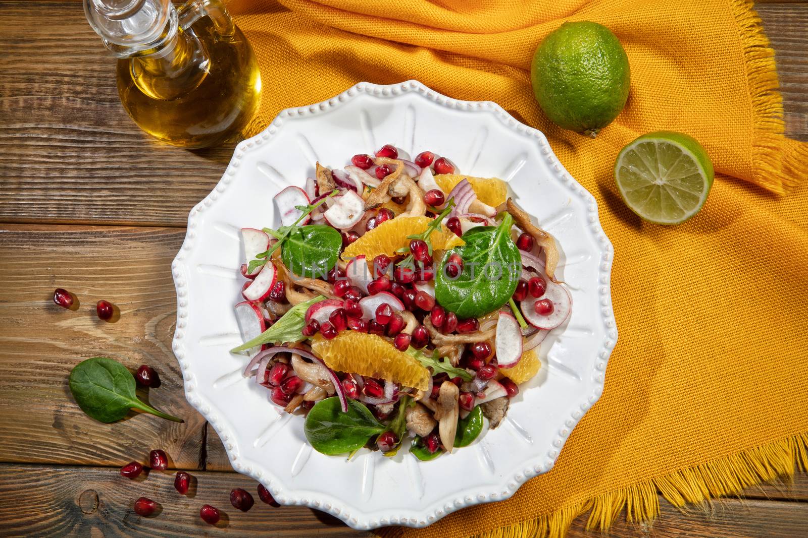 Plate with salad on a wooden desk and fabric