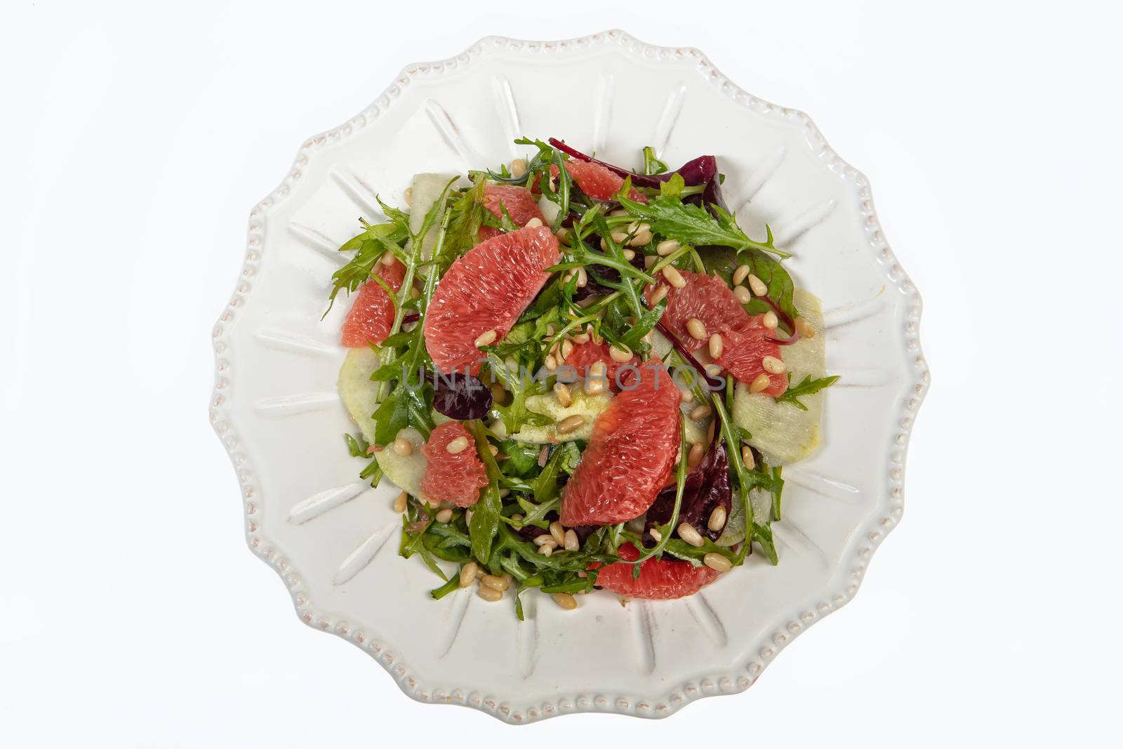 Porcelain plate with salad on an isolated studio background