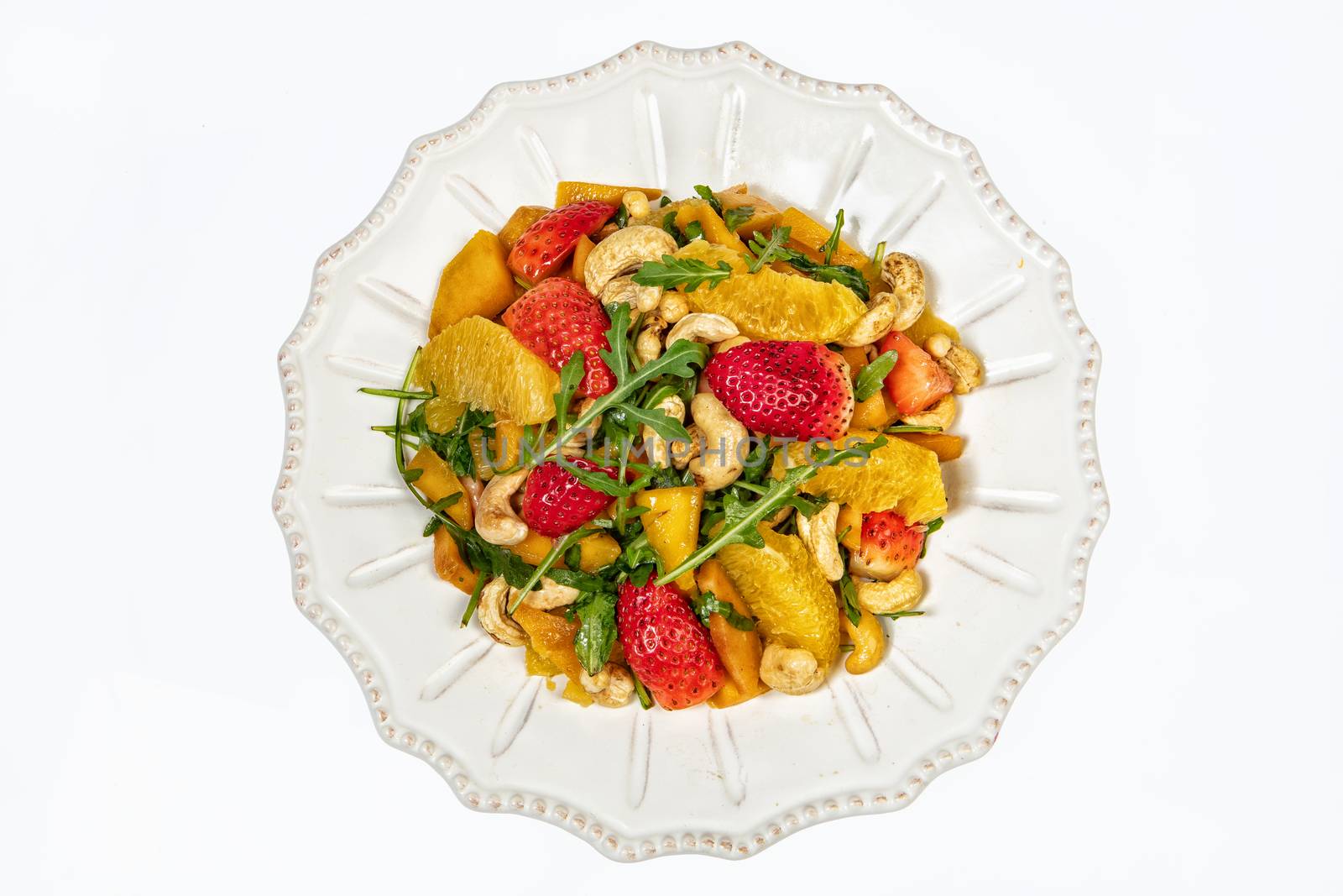 Porcelain plate with salad on an isolated studio background