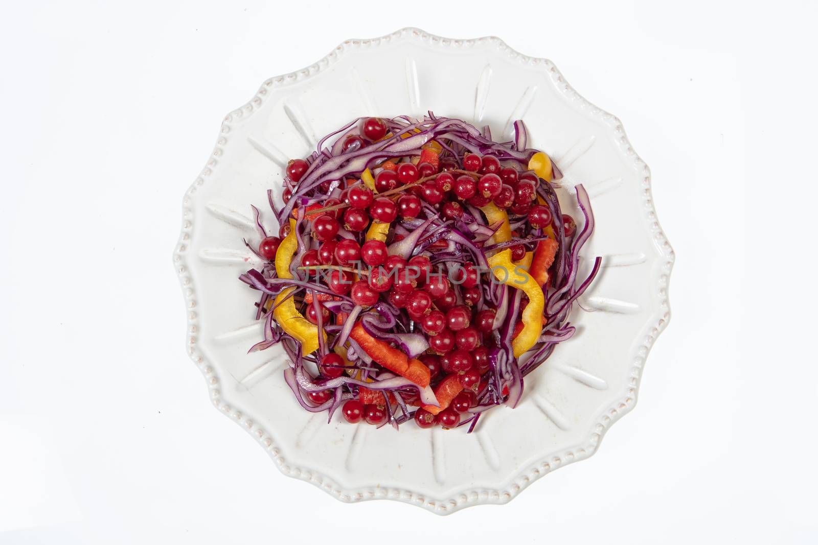 Porcelain plate with salad on an isolated studio background