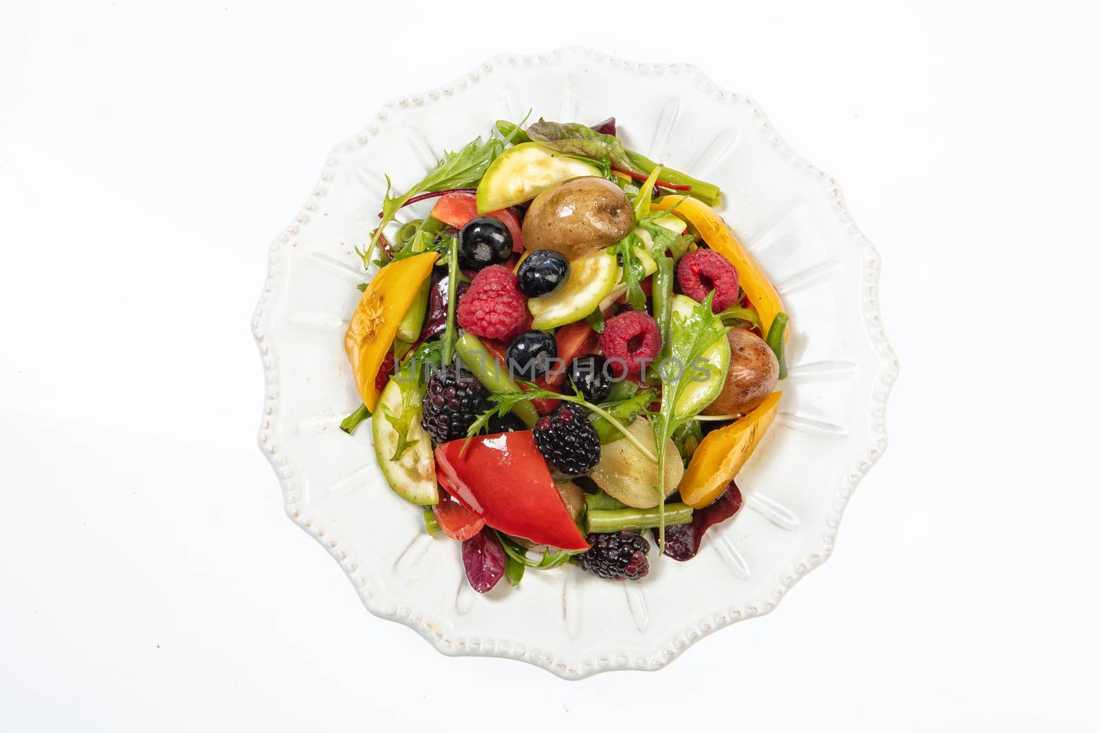 Porcelain plate with salad on an isolated studio background