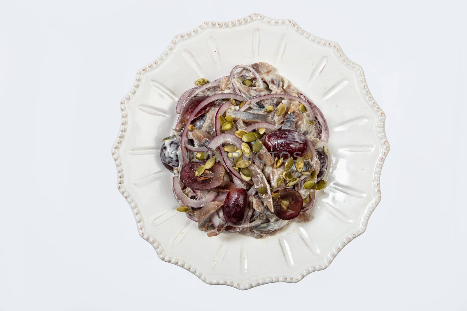 Porcelain plate with salad on an isolated studio background