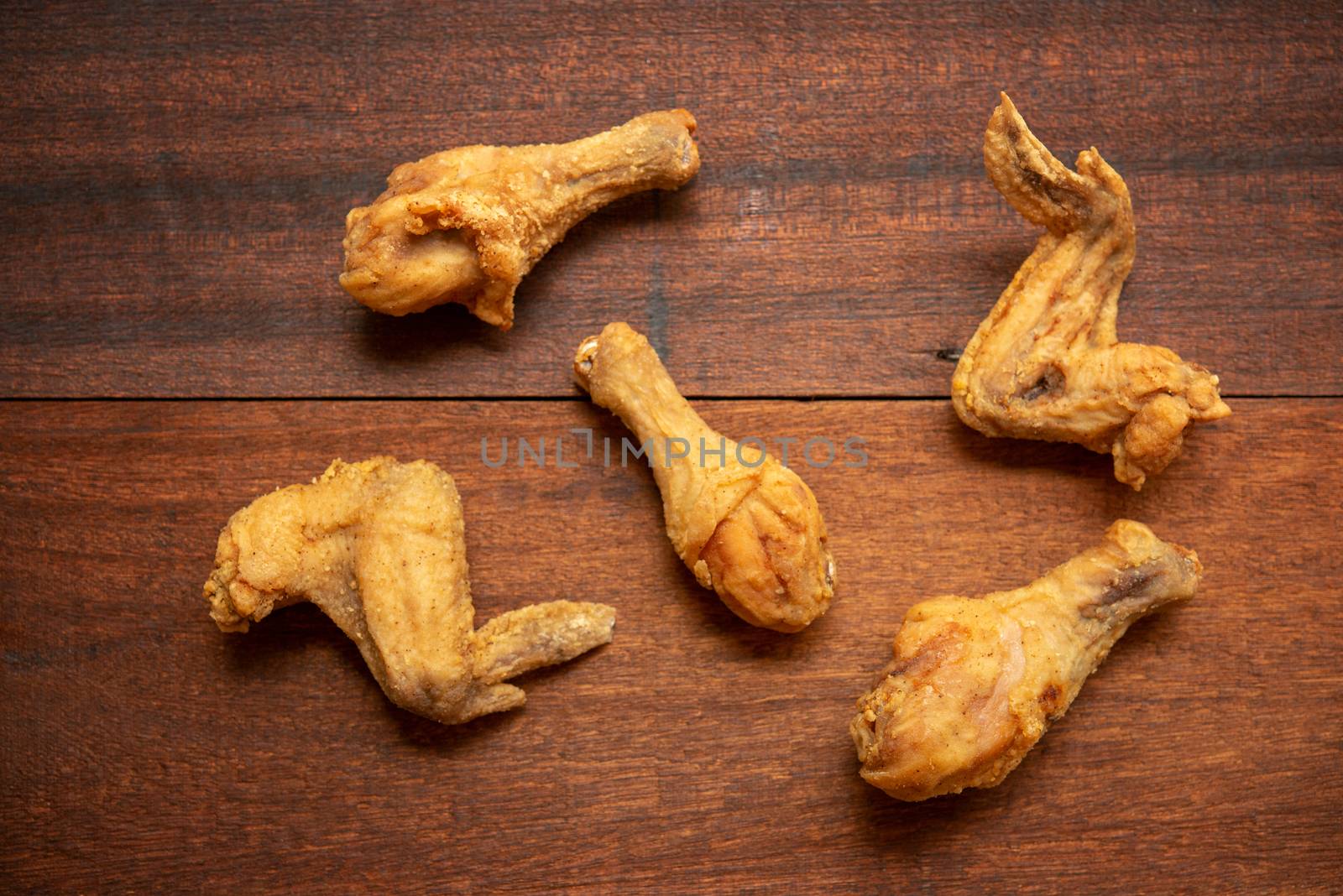Top view flat lay original recipe fried chickens, on dark wooden background.