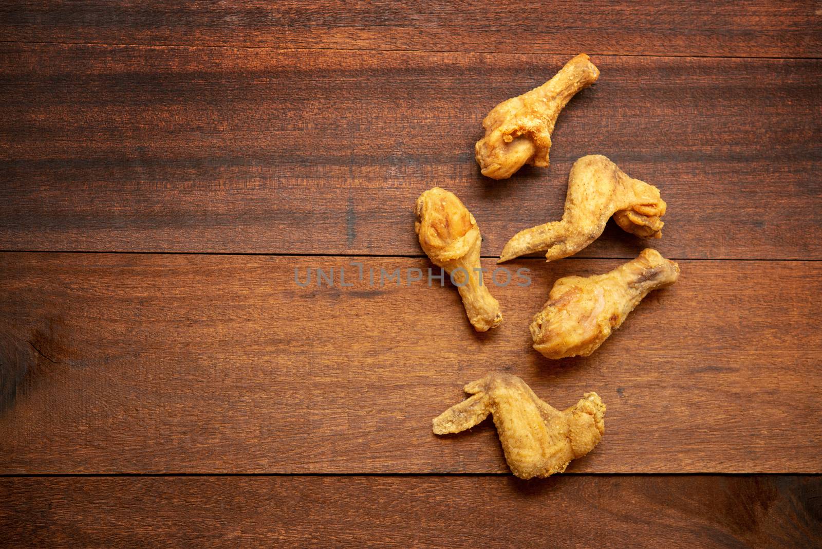 Top view flat lay original recipe fried chickens with copy space, on dark wooden background.