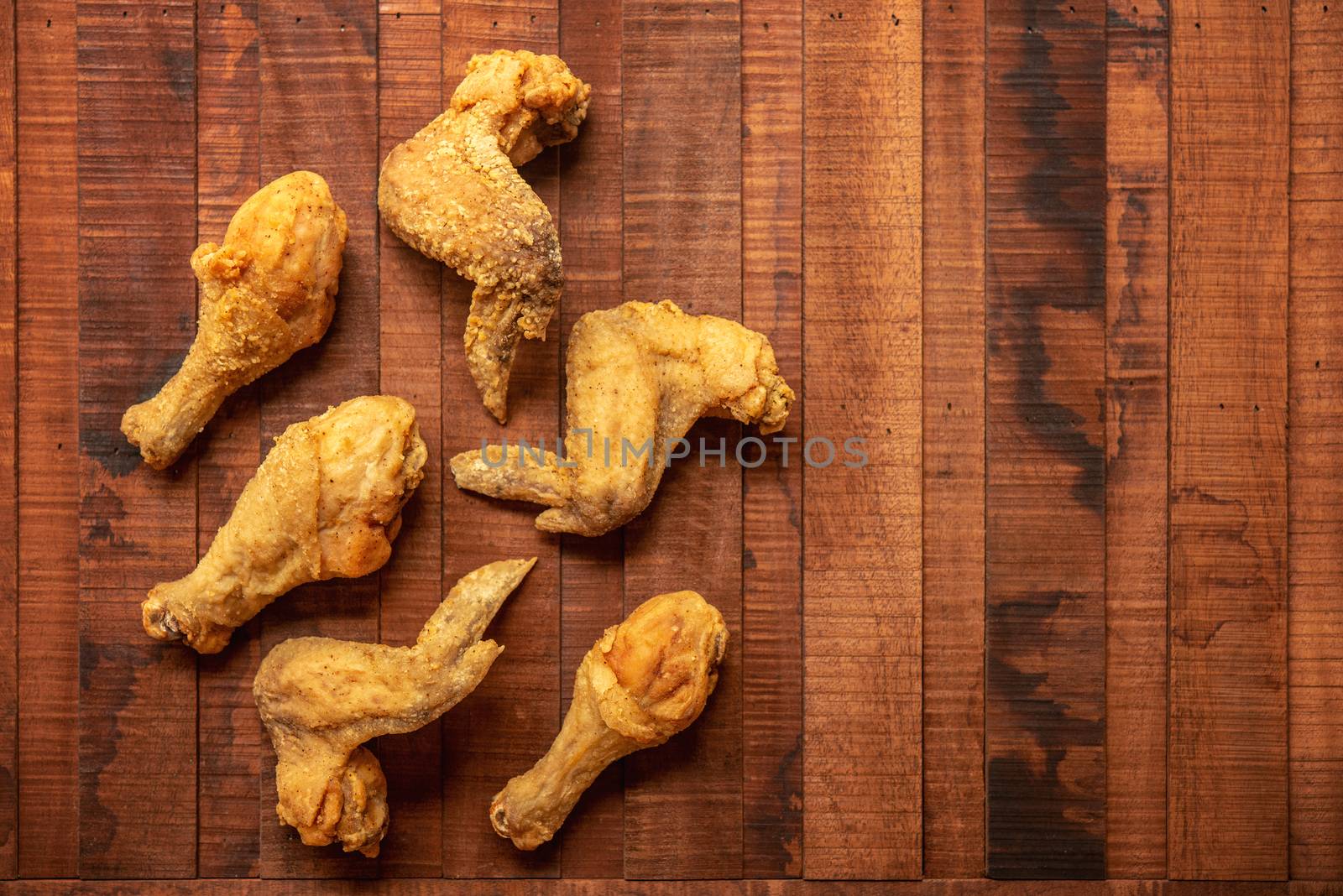 Top view flat lay original recipe fried chickens with copy space, on dark wooden background.