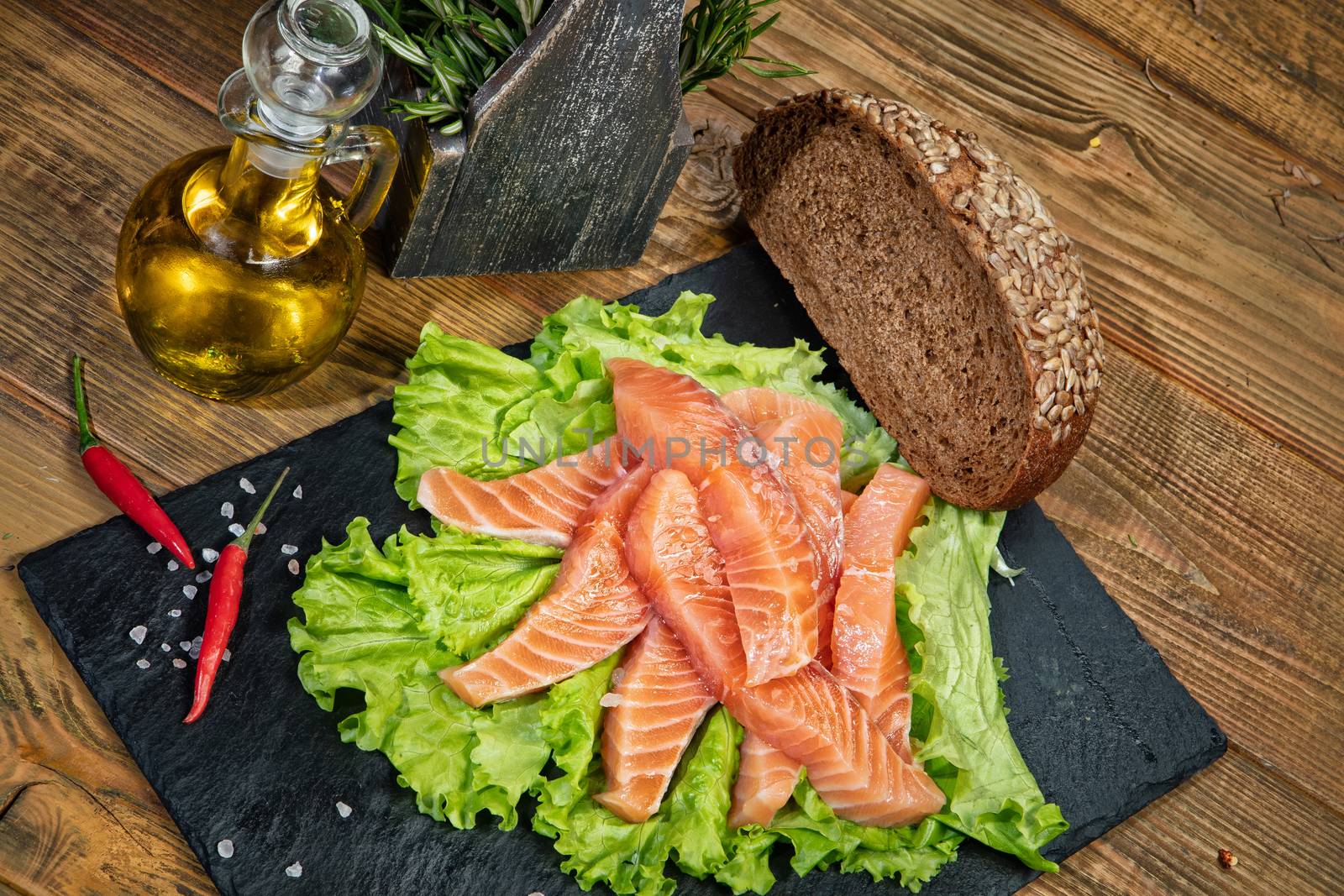 Red fish and limes on an old wooden desk