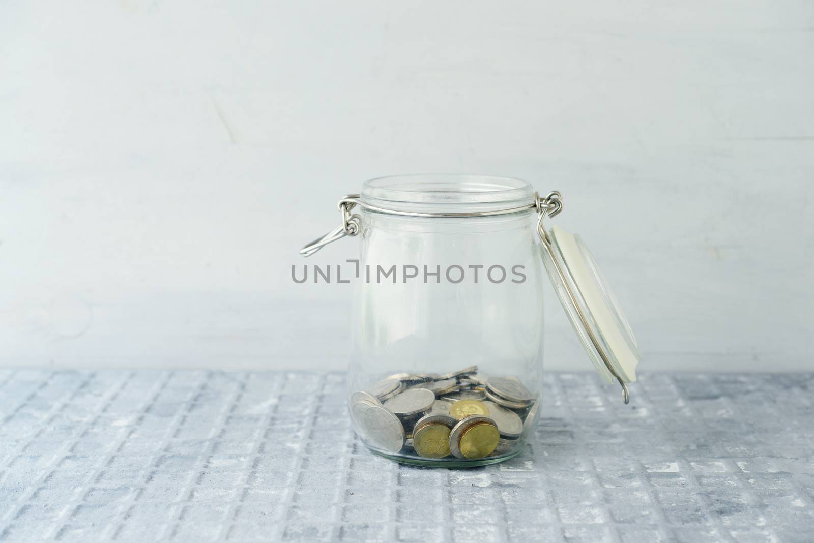 Coins in glass money jar, financial concept. 