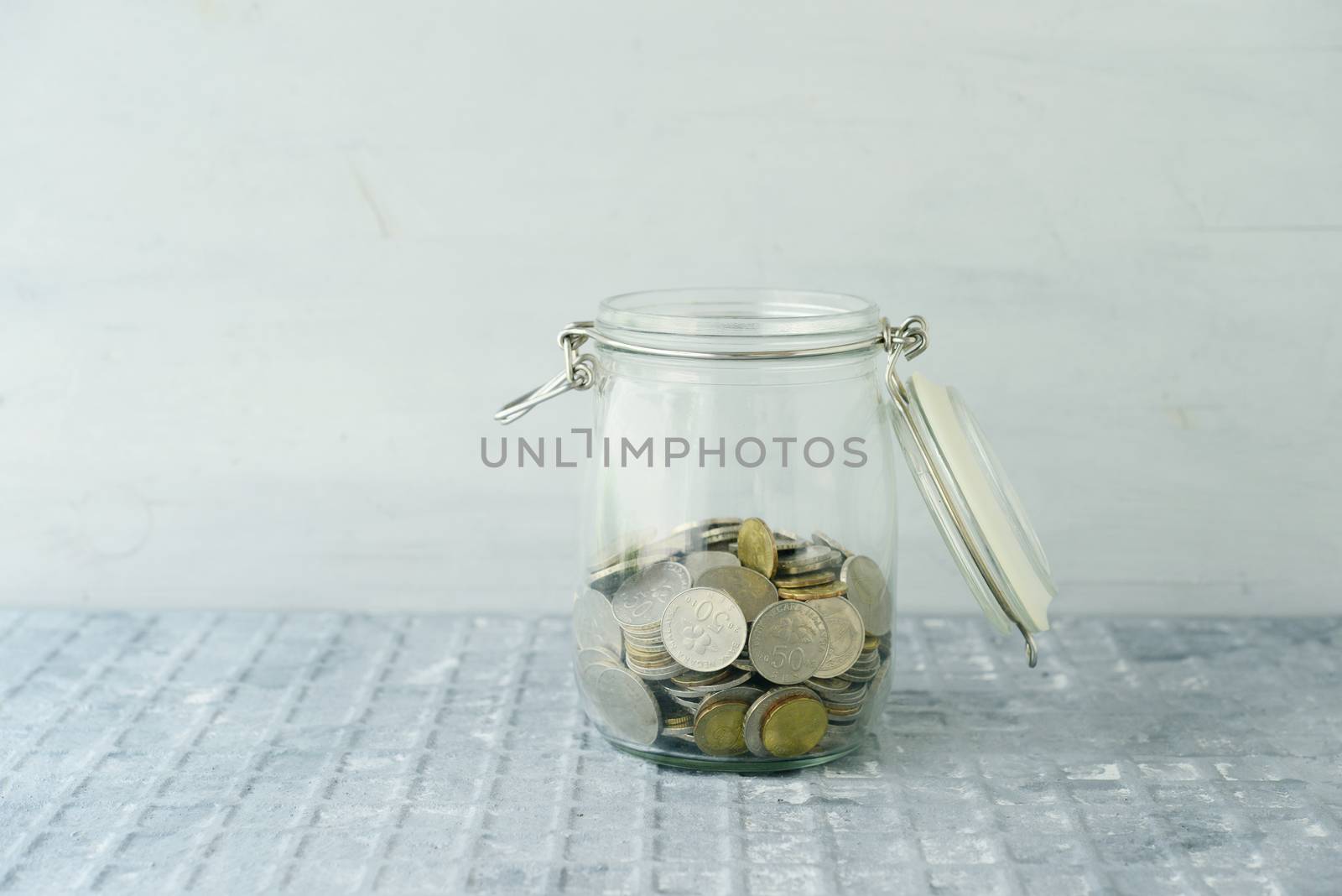 Coins in glass money jar, financial concept. 