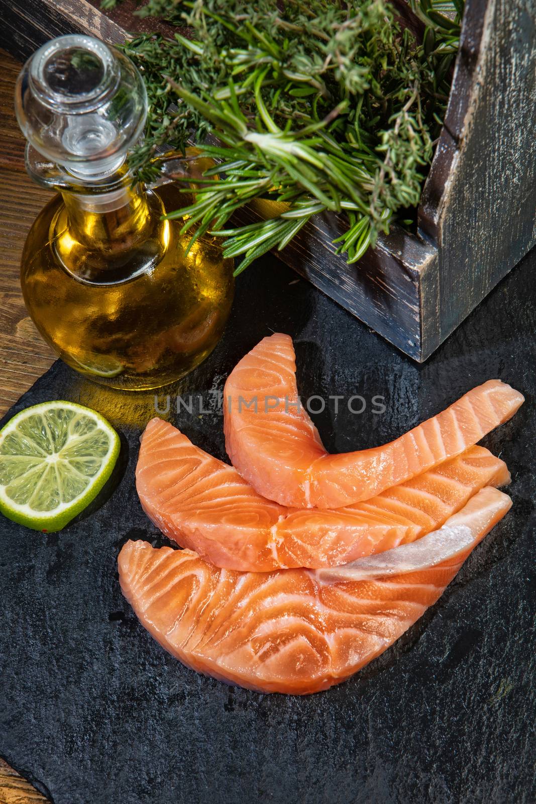 Red fish and limes on an old wooden desk