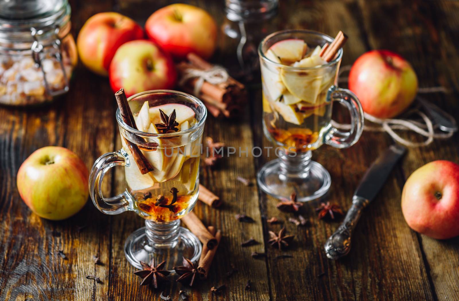 Homemade Spiced Beverage with Sliced Apples and Some Kitchen Herbs.