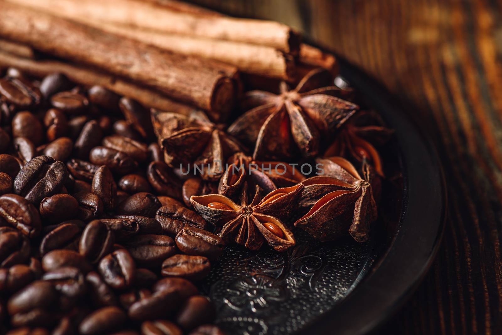 Coffee Beans with Cinnamon and Star Anise on Metal Plate.