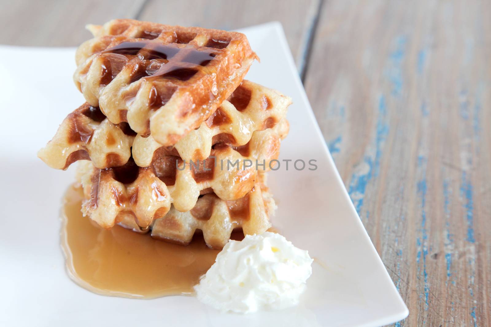 Maple syrup waffle with vanilla whipped cream by haiderazim