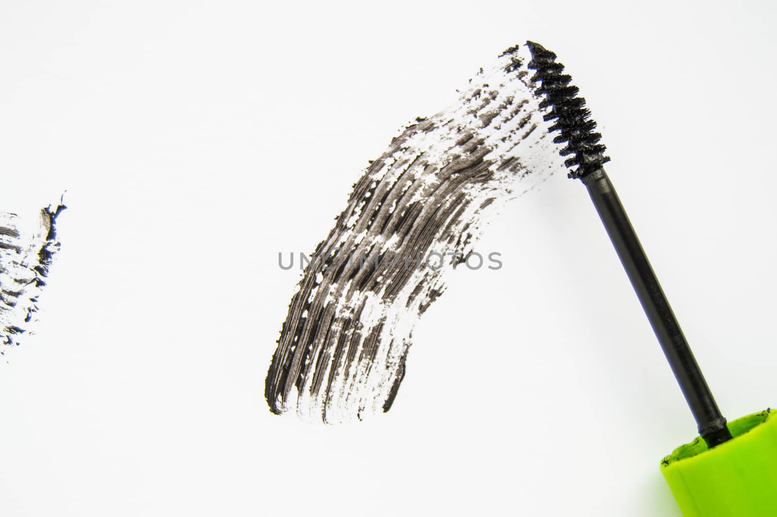 Black ink smear and green brush isolated on white.