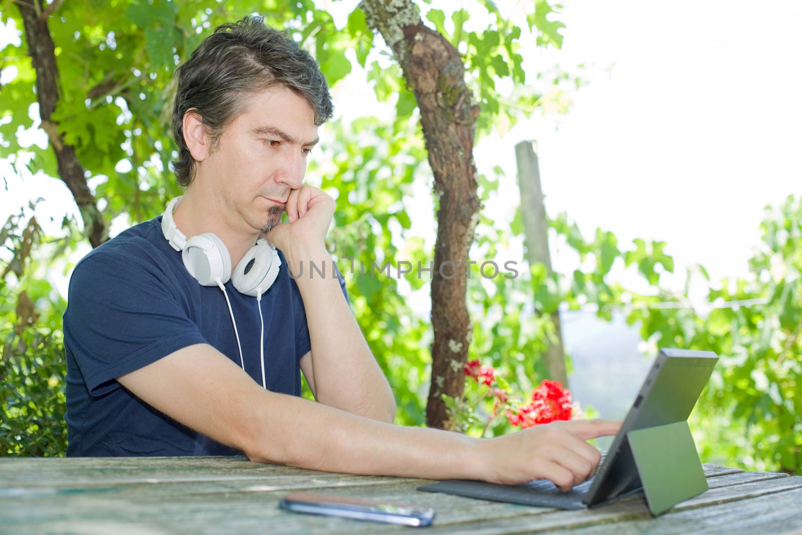 casual man working with a tablet pc, outdoor