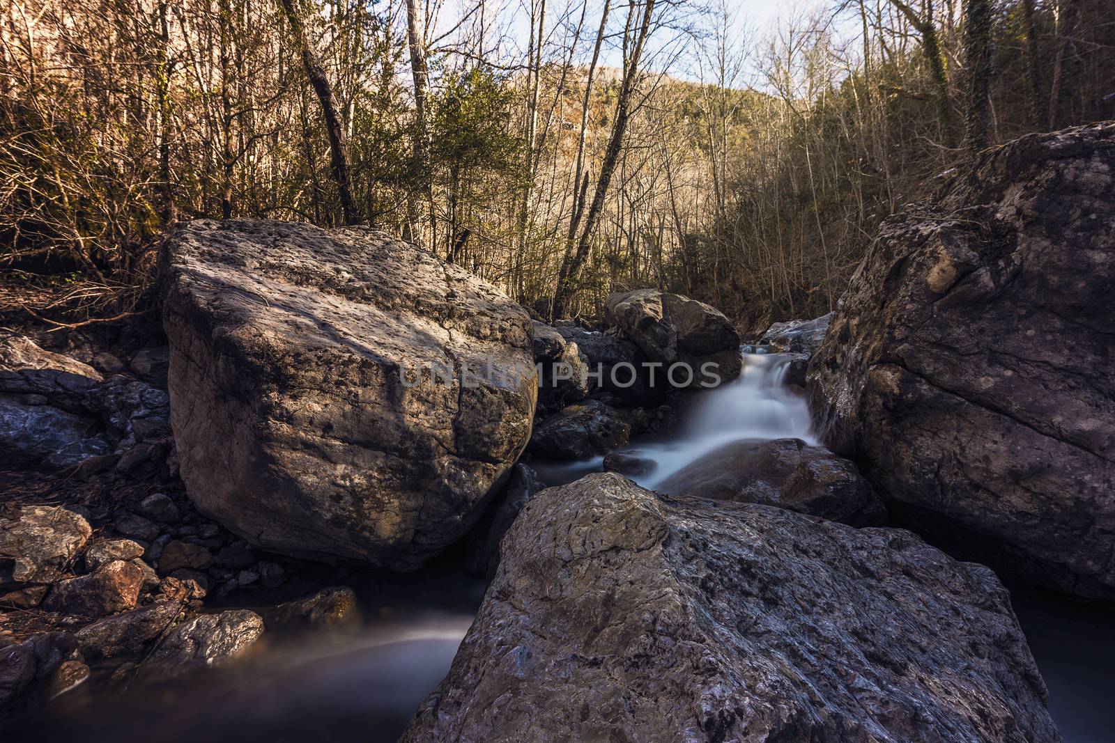 long exposure of a river with big stones in autumn. Effect of water in movement