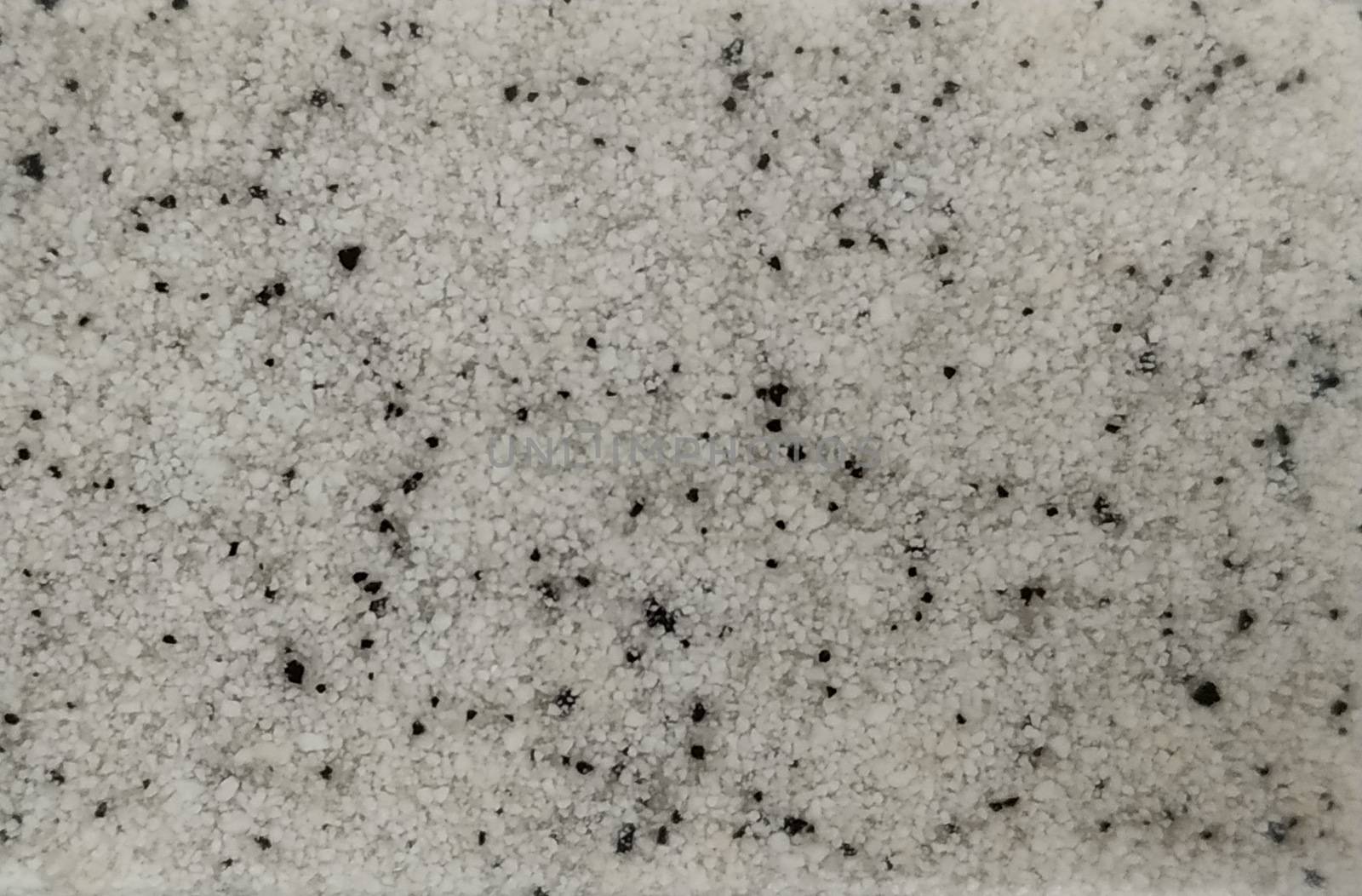 White granite with black splashes of the small fraction. Background, texture.