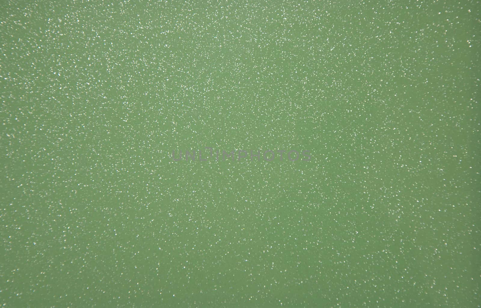 Green pearlescent transparent background with metal splashes. Background. Texture.