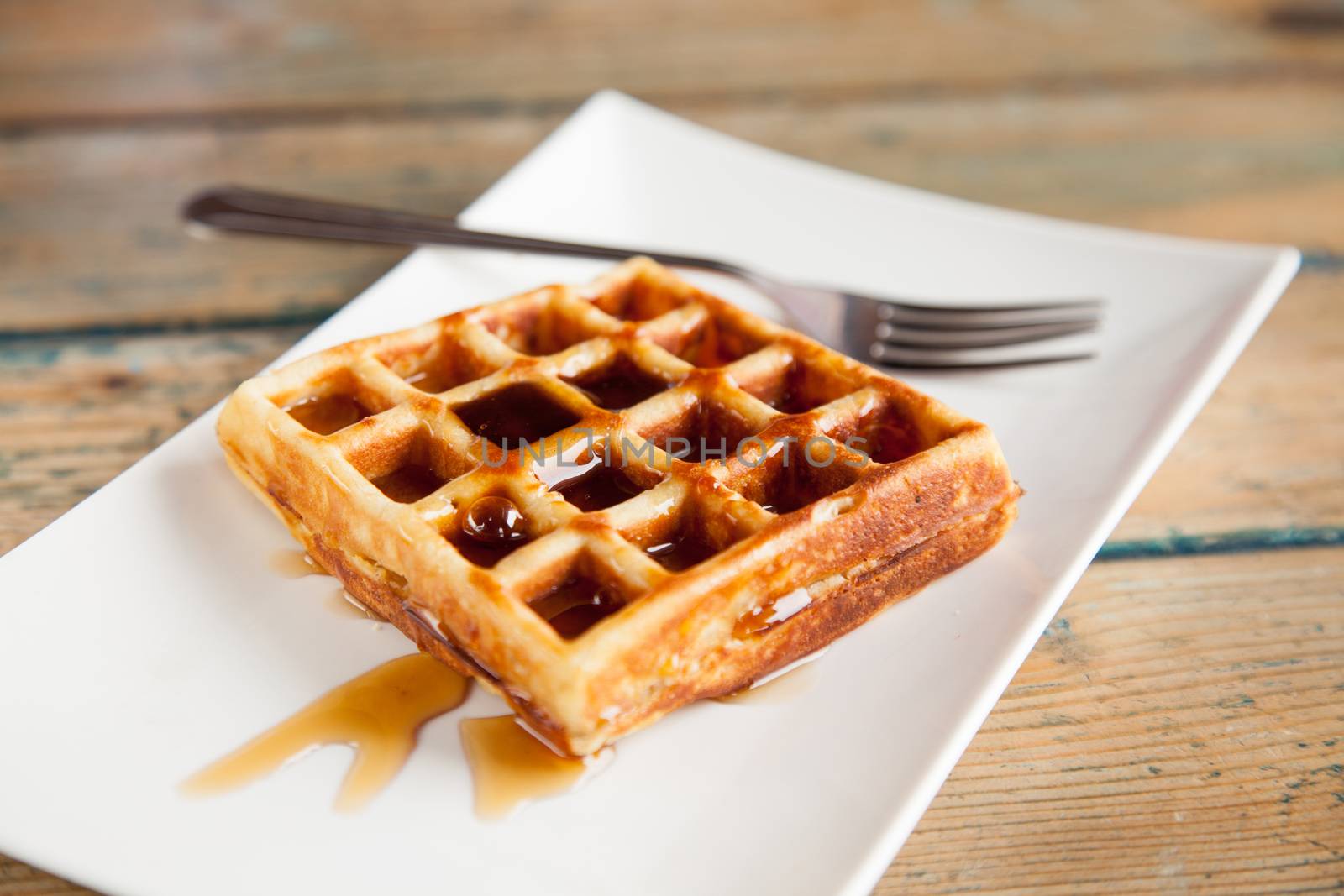 Maple syrup waffle with fork by haiderazim