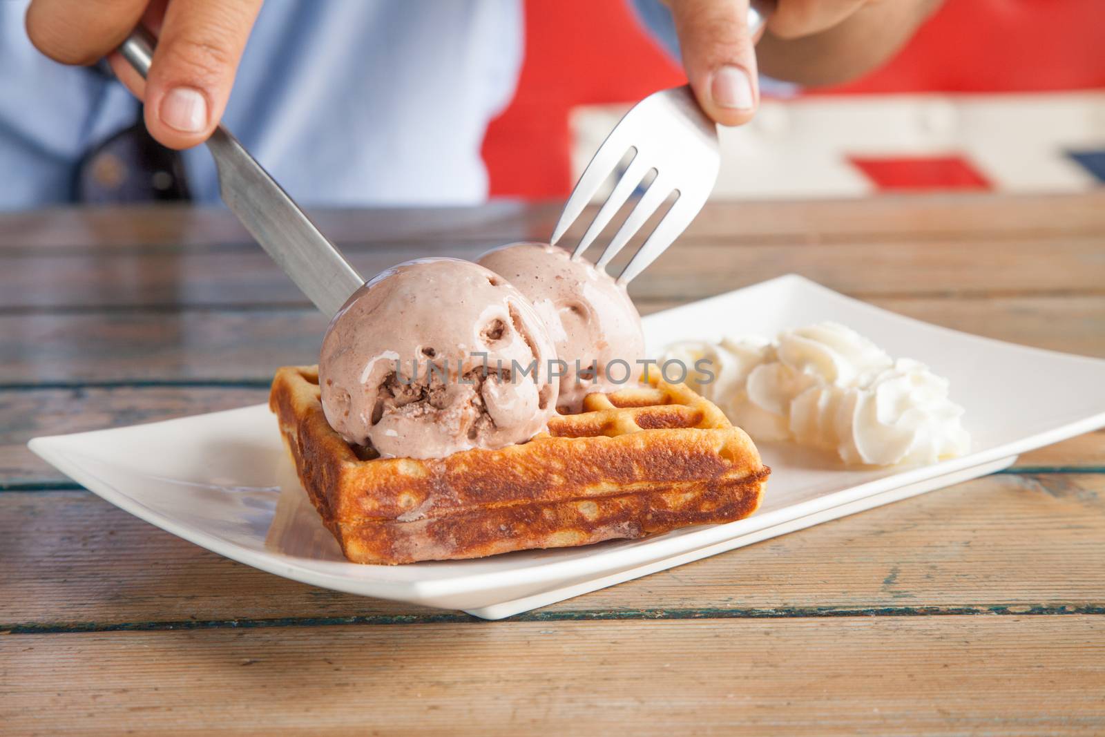 Eating Ice cream waffle and whipped cream with Fork and Knife