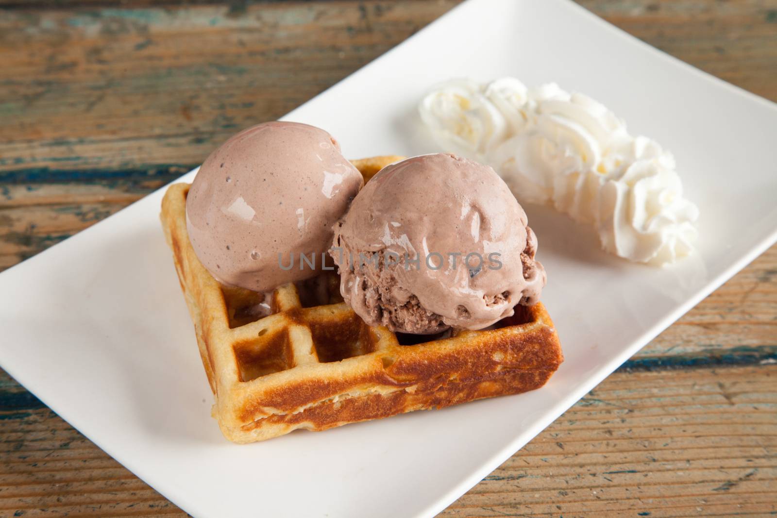 Ice cream waffle and whipped cream by haiderazim
