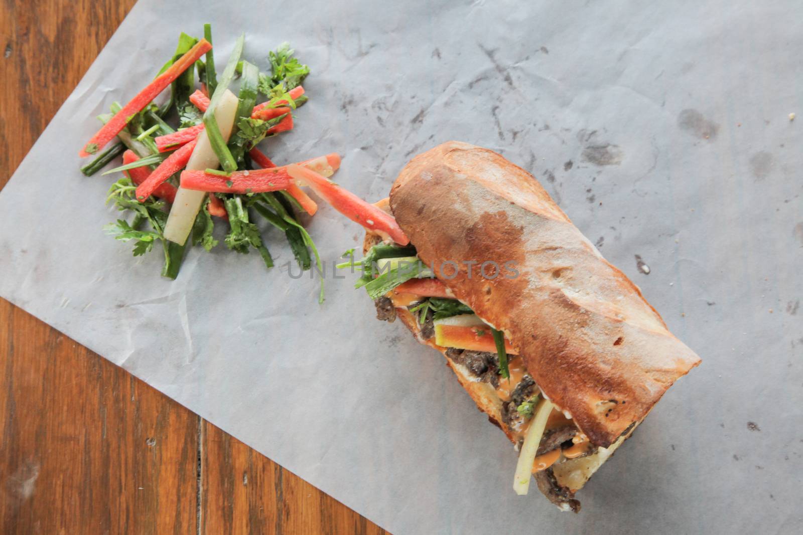 Vietnamese Banh Mi Sandwich and veggies from top angle  by haiderazim