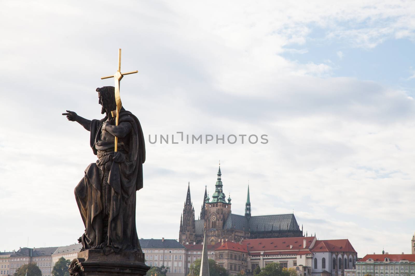 Statue of John the Baptist, Prague Castle in the background, Czech Republic