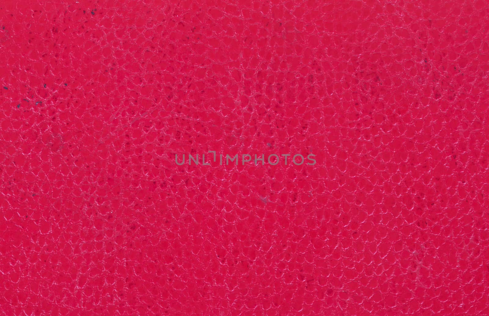 Bright red leather background, part of an old binder folder