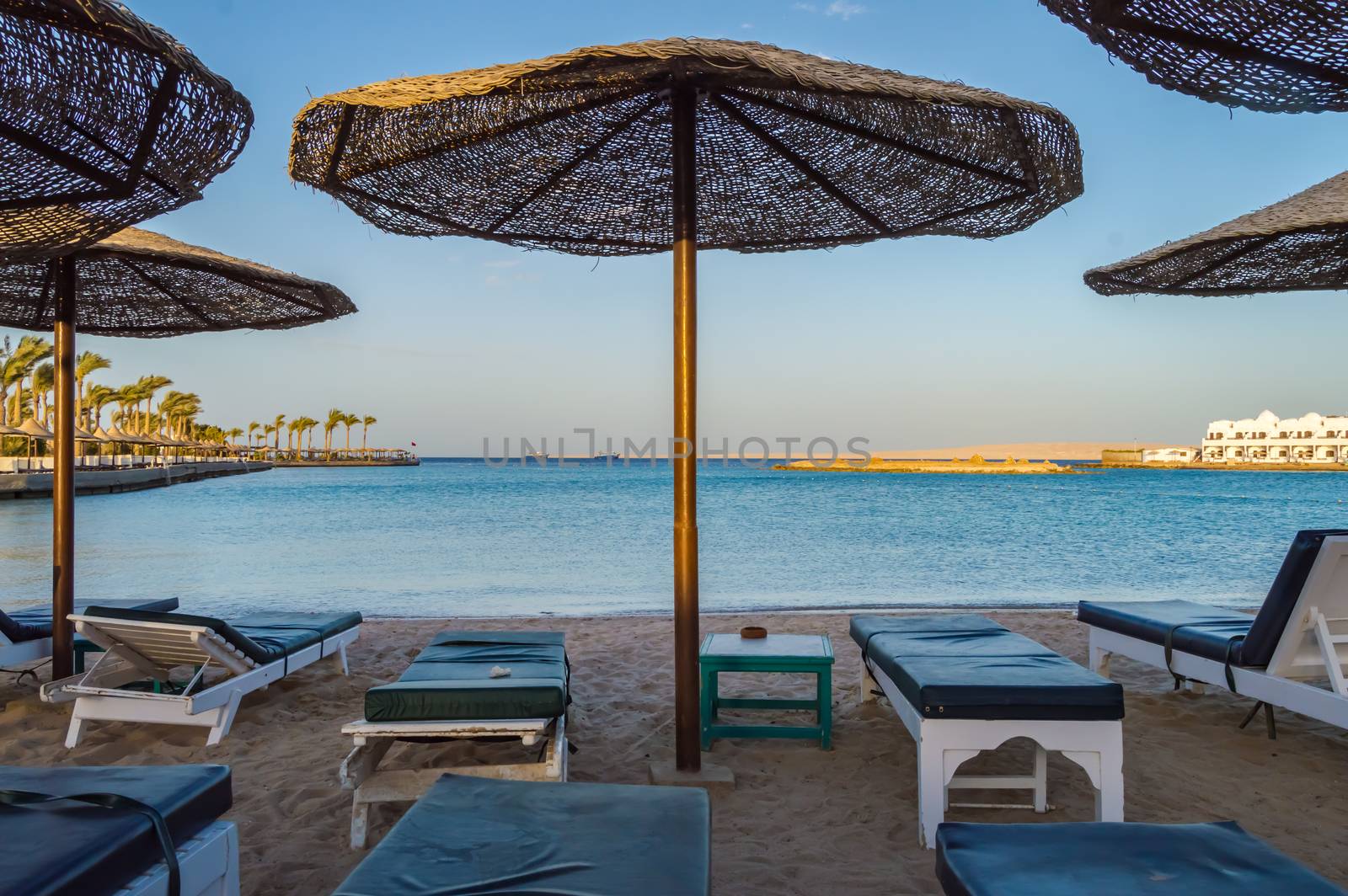 Deckchairs and parasols on a beach of the Red Sea in Hurghada Egypt