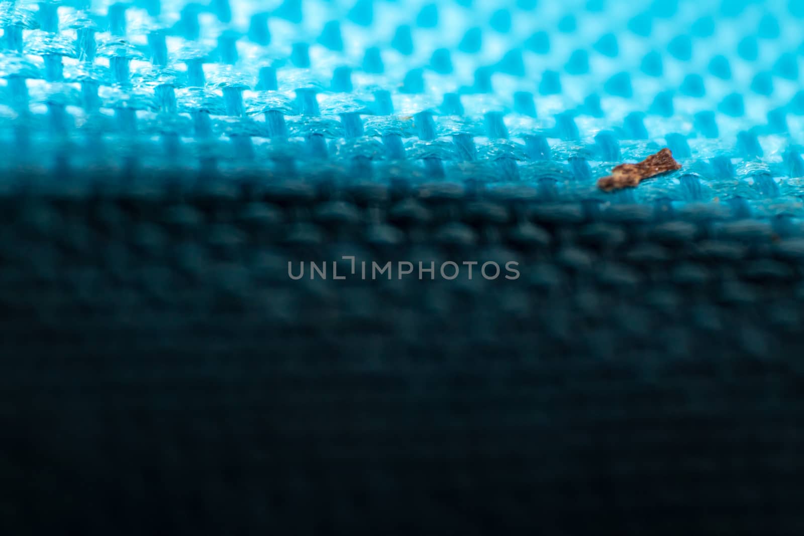 a macro shoot of swollen dirty braided blue cloth texture. bottom side got shadow.