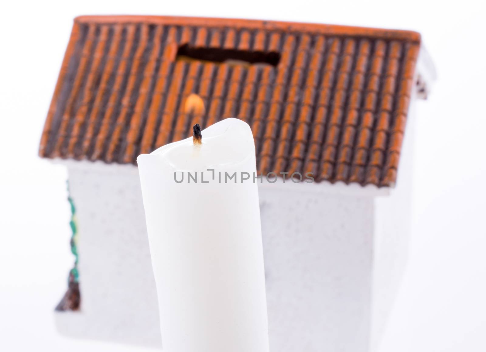 house and candle side by side on a white background