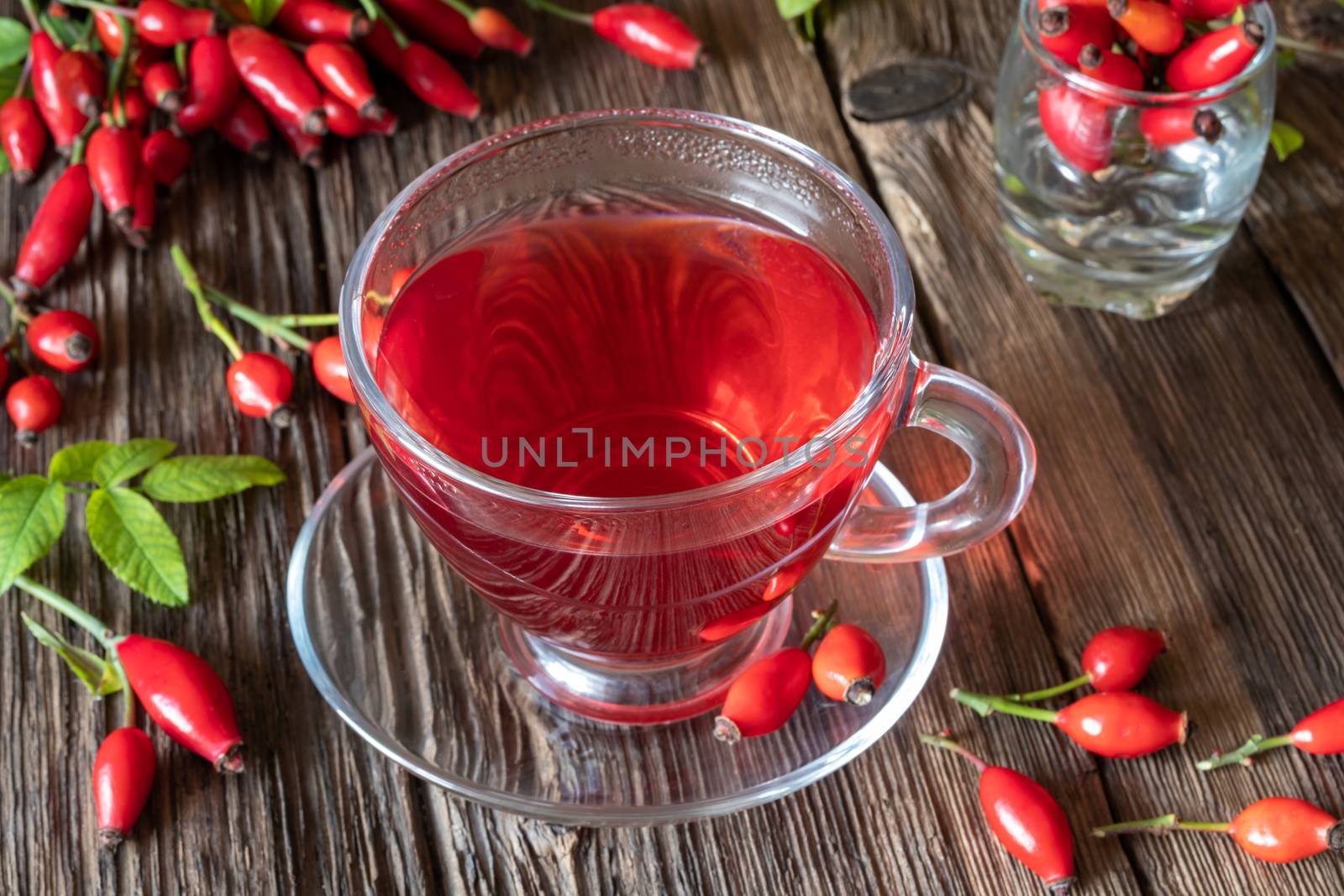 A cup of rose hip tea with fresh berries