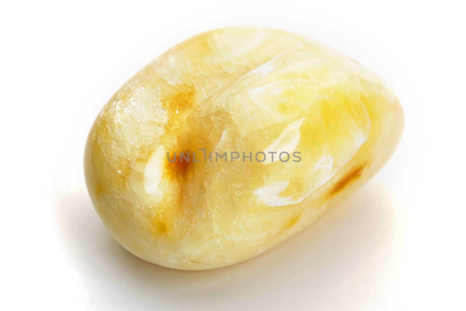 Natural amber. A piece of yellow opaque natural amber on white background. by igor_stramyk
